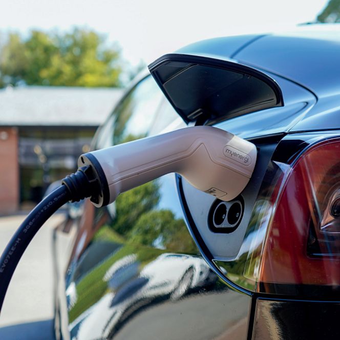 Electric car charging at a charging station