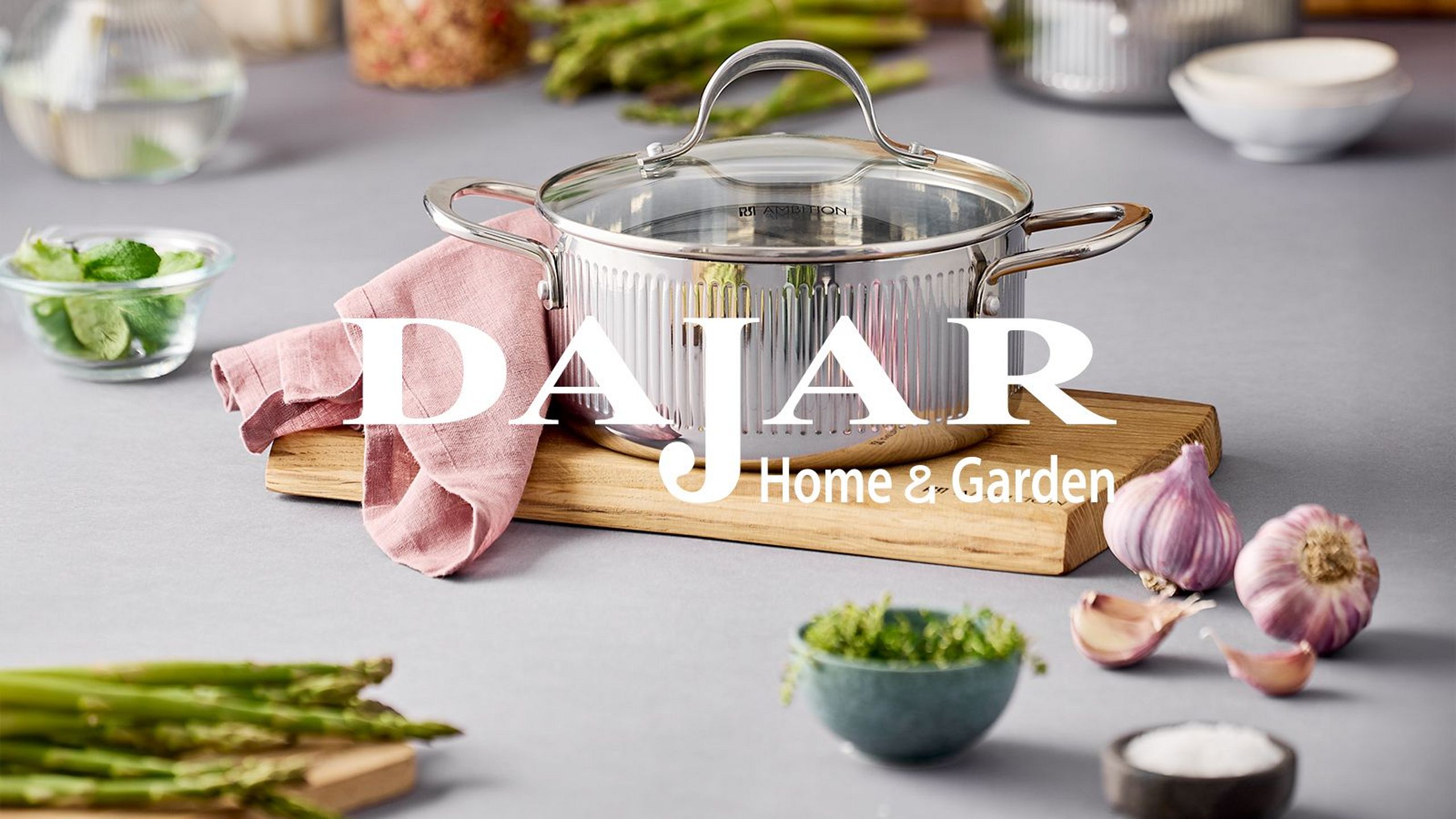 An Ambition pot in a kitchen setting with vegetables and the Dajar Home & Garden logo.