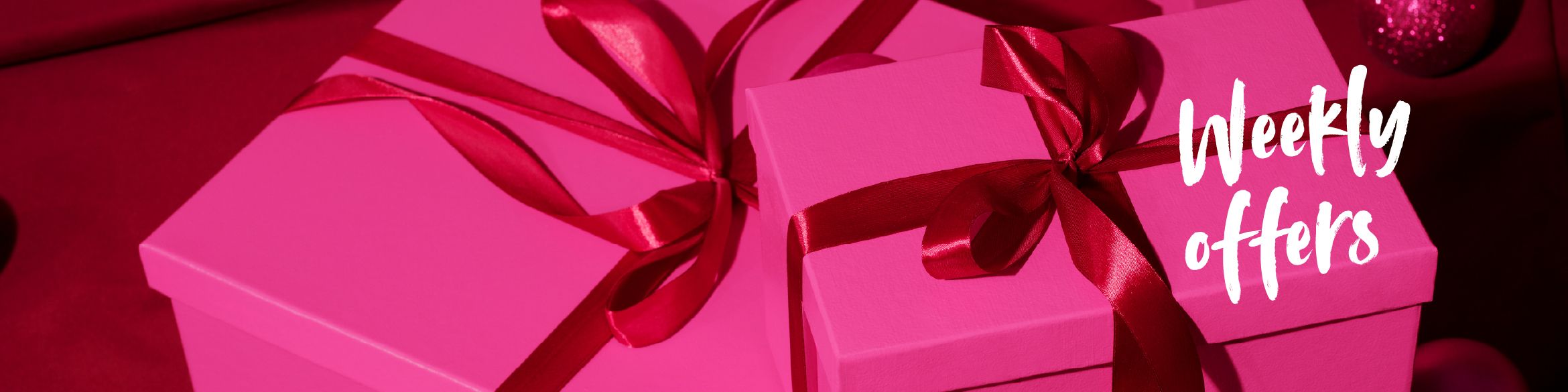 Pink gifts decorated with a red ribbon on a background of the same color, with the inscription ‘PRODUCTS OF THE WEEK’.