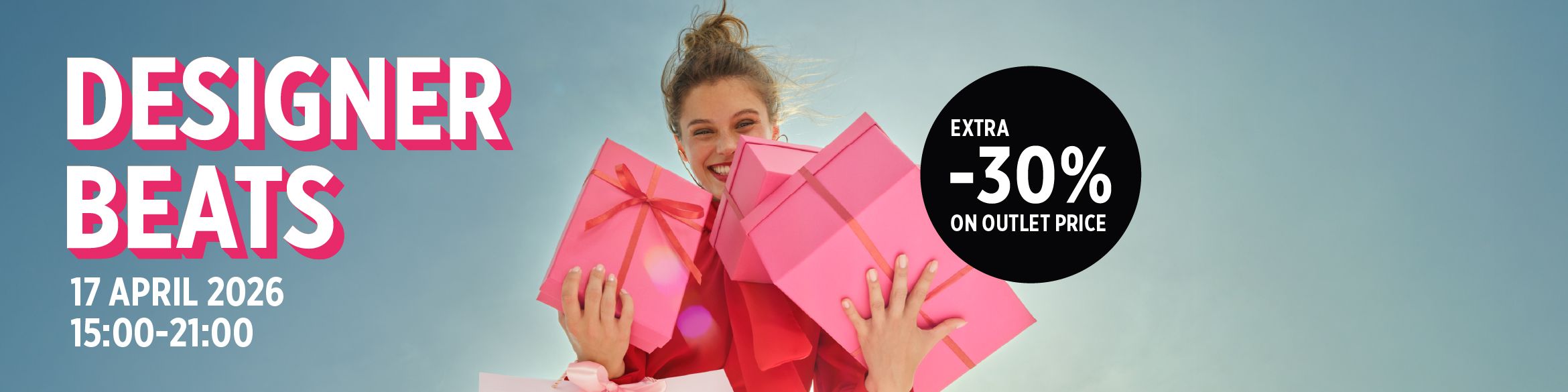 Smiling woman holding pink gifts against the sky.