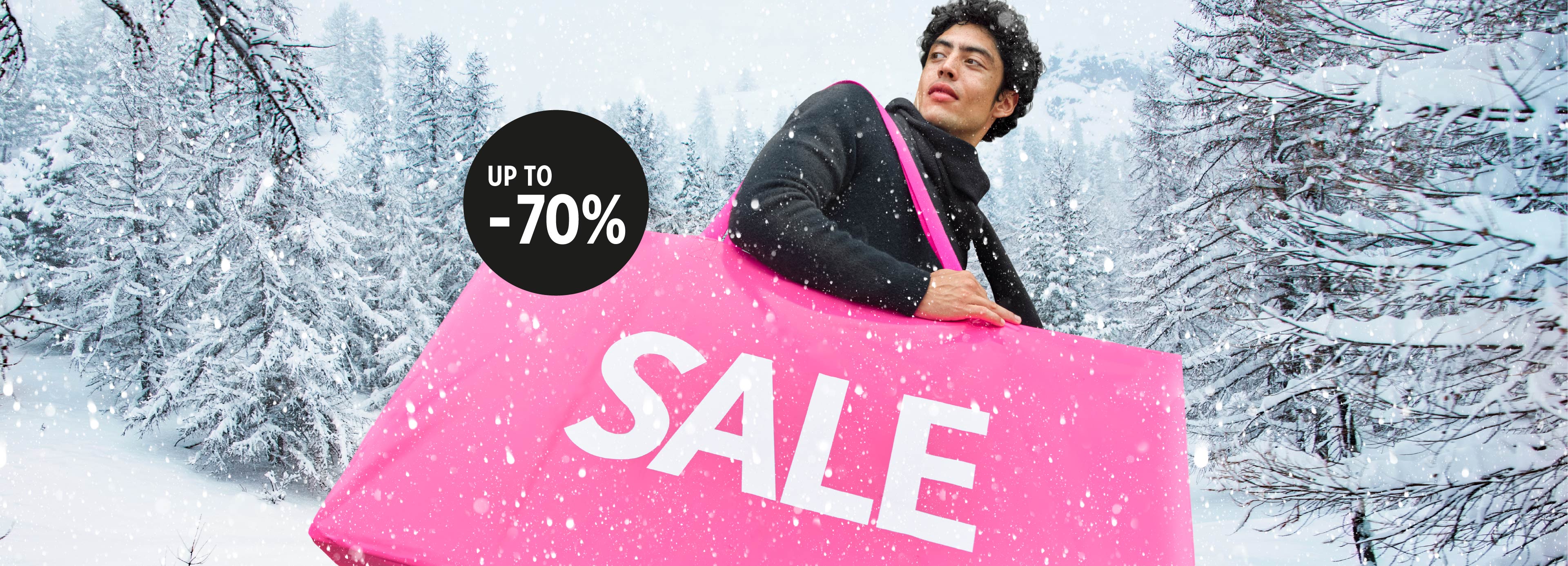 A man holding a pink bag with the word SALE, with a snowy landscape in the background, advertisement with the phrase 'Always up to -70% off'.