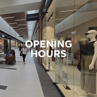 Interior of Designer Outlet Kraków with the Greenpoint store window and the text "Opening Hours" in the center of the image.